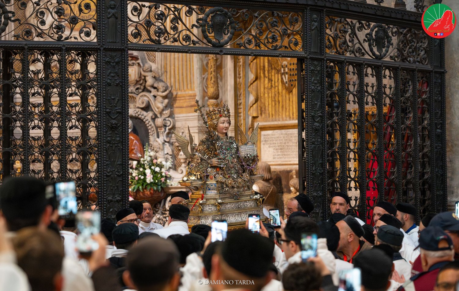 Devotees in front of the gate of Saint Agatha's chapel in Catania Cathedral.