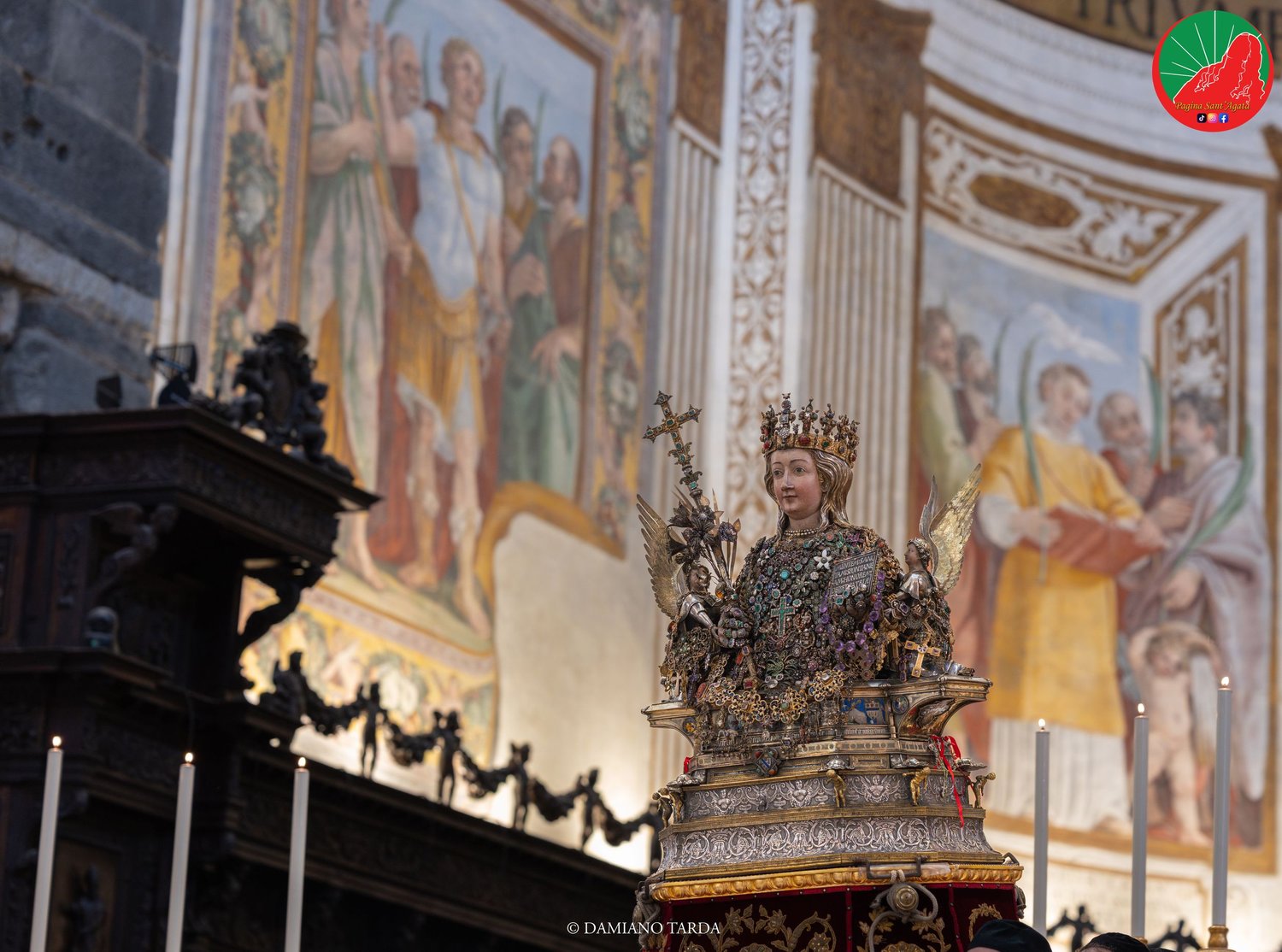 The bust of Saint Agatha in the presbytery of the Cathedral, in front of the apse frescoes.