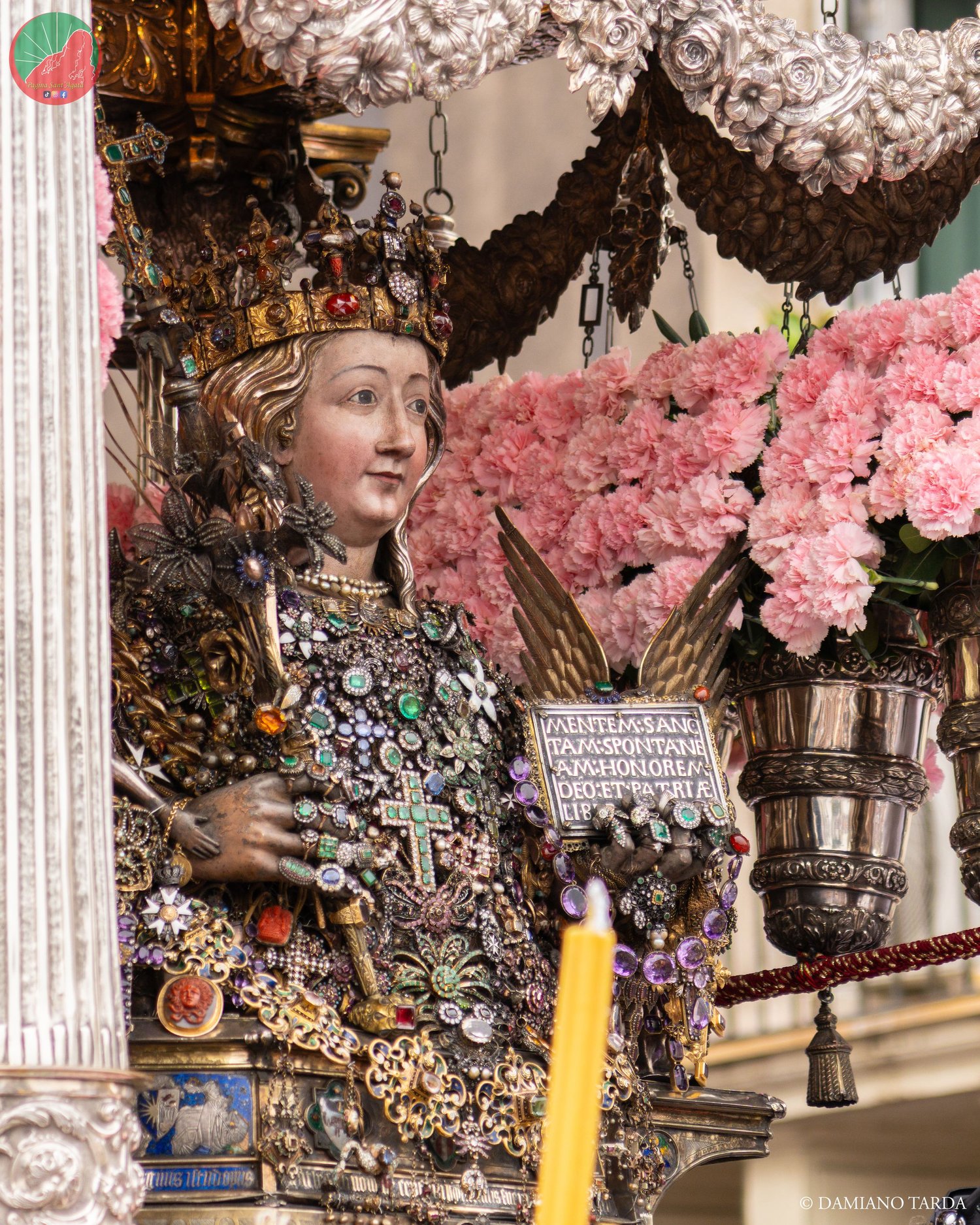 The bust of Saint Agatha on the fercolo decked with pink carnations, February feast in Catania.