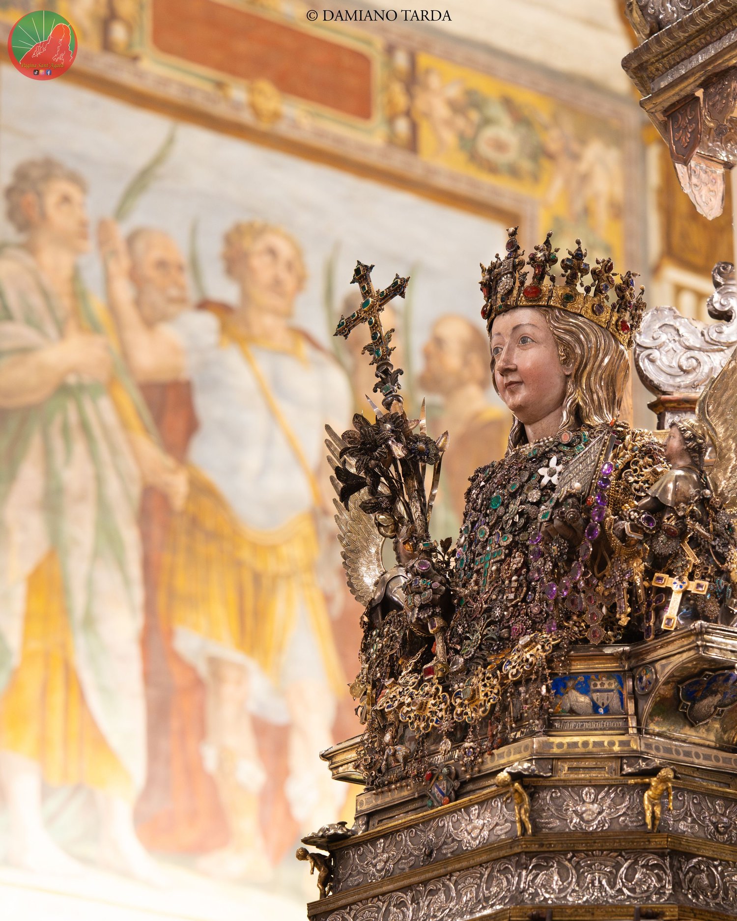 The reliquary bust of Saint Agatha in front of the frescoes of Catania Cathedral.