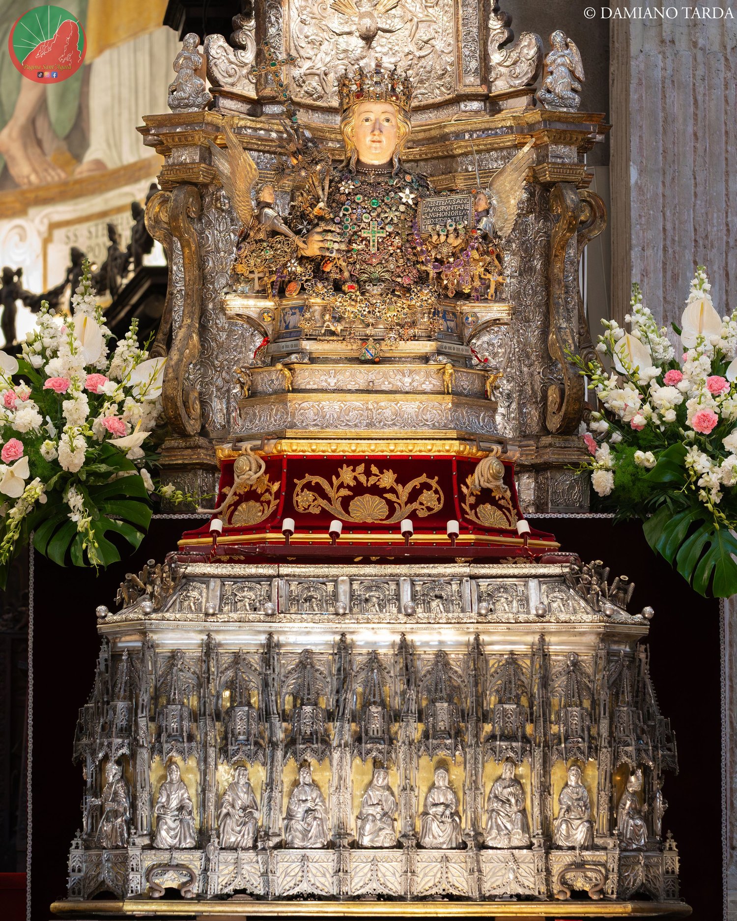 The silver casket with the relics of Saint Agatha in Catania Cathedral, among flowers.