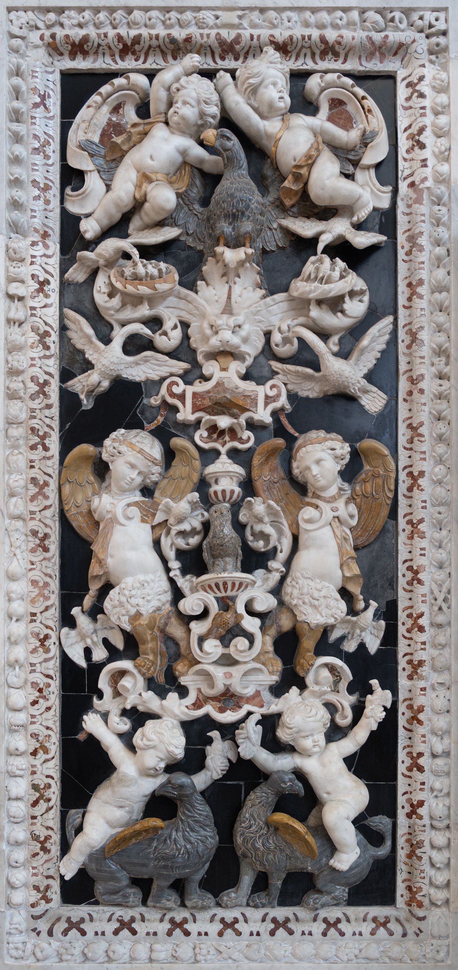 Pannello in marmi mischi con putti e uccelli scolpiti a rilievo su fondo di marmo nero. Palermo, Chiesa del Gesù (Casa Professa).