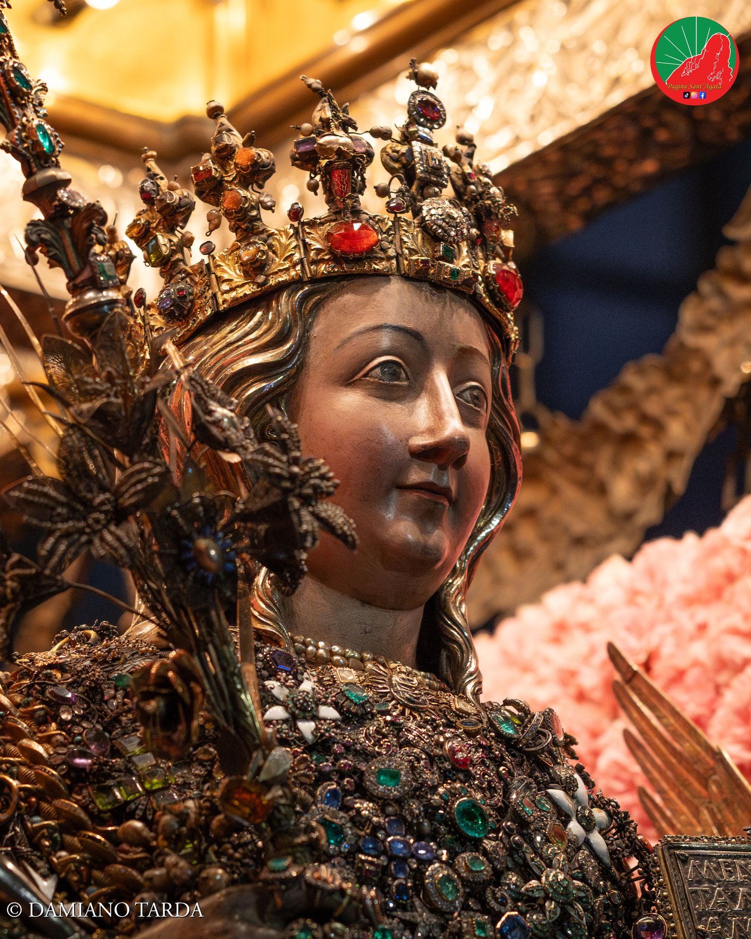 Night close-up of the reliquary bust of Saint Agatha set with traditional jewels and precious ex-votos, Catania