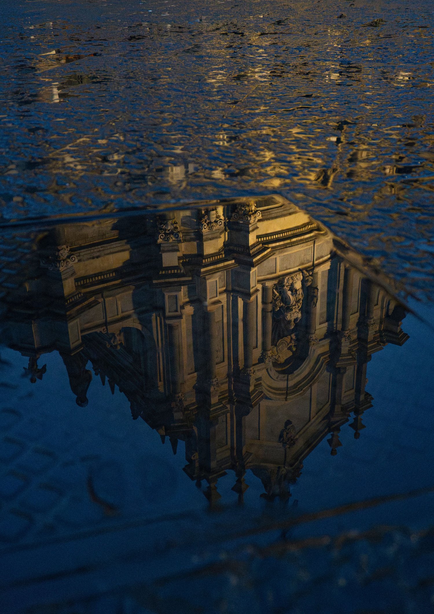 Reflection of Catania's Baroque Cathedral in water, conceptual photography, play of light.