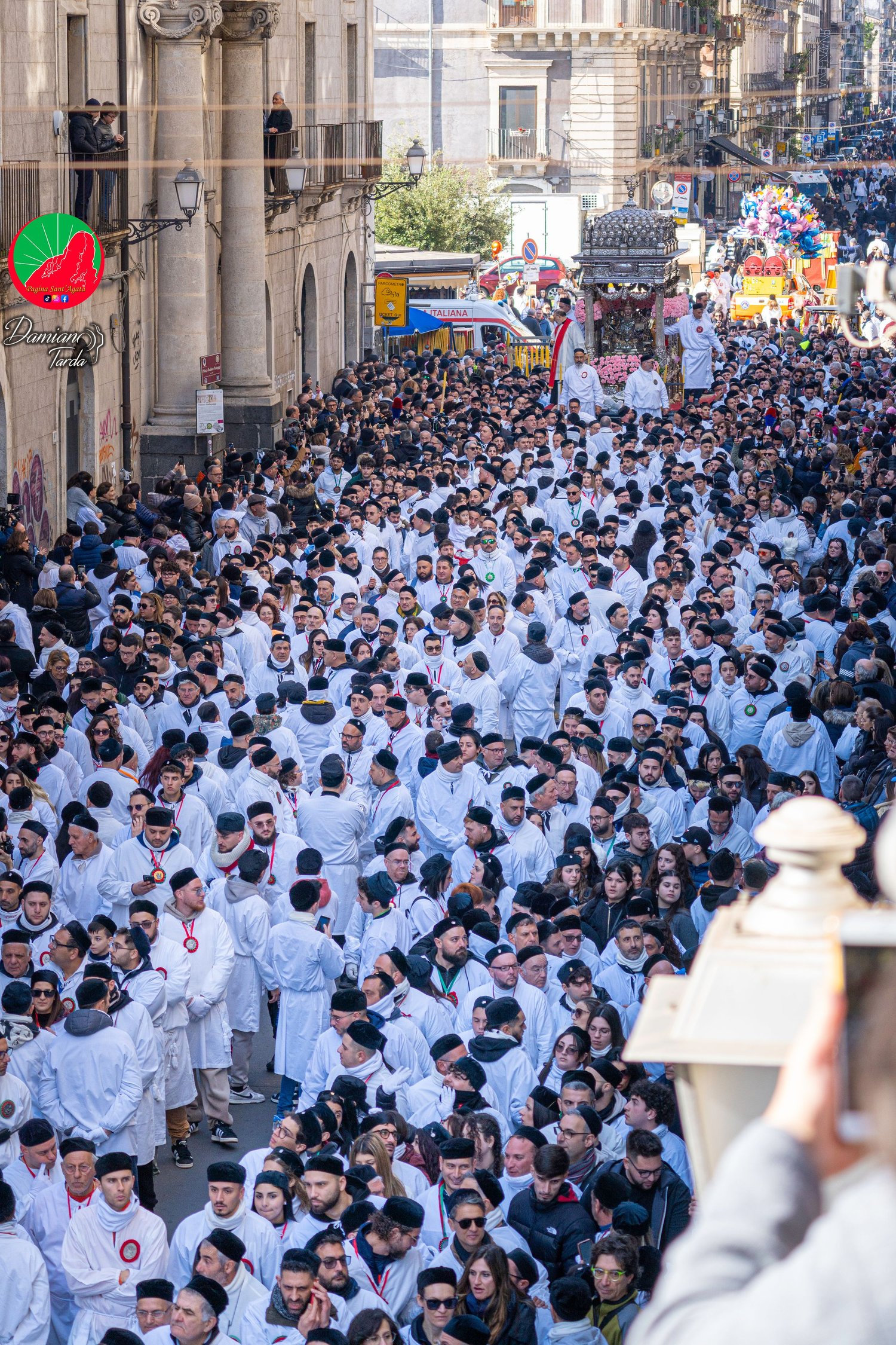 Portrait of devotees in white robes during the procession of Saint Agatha in Catania