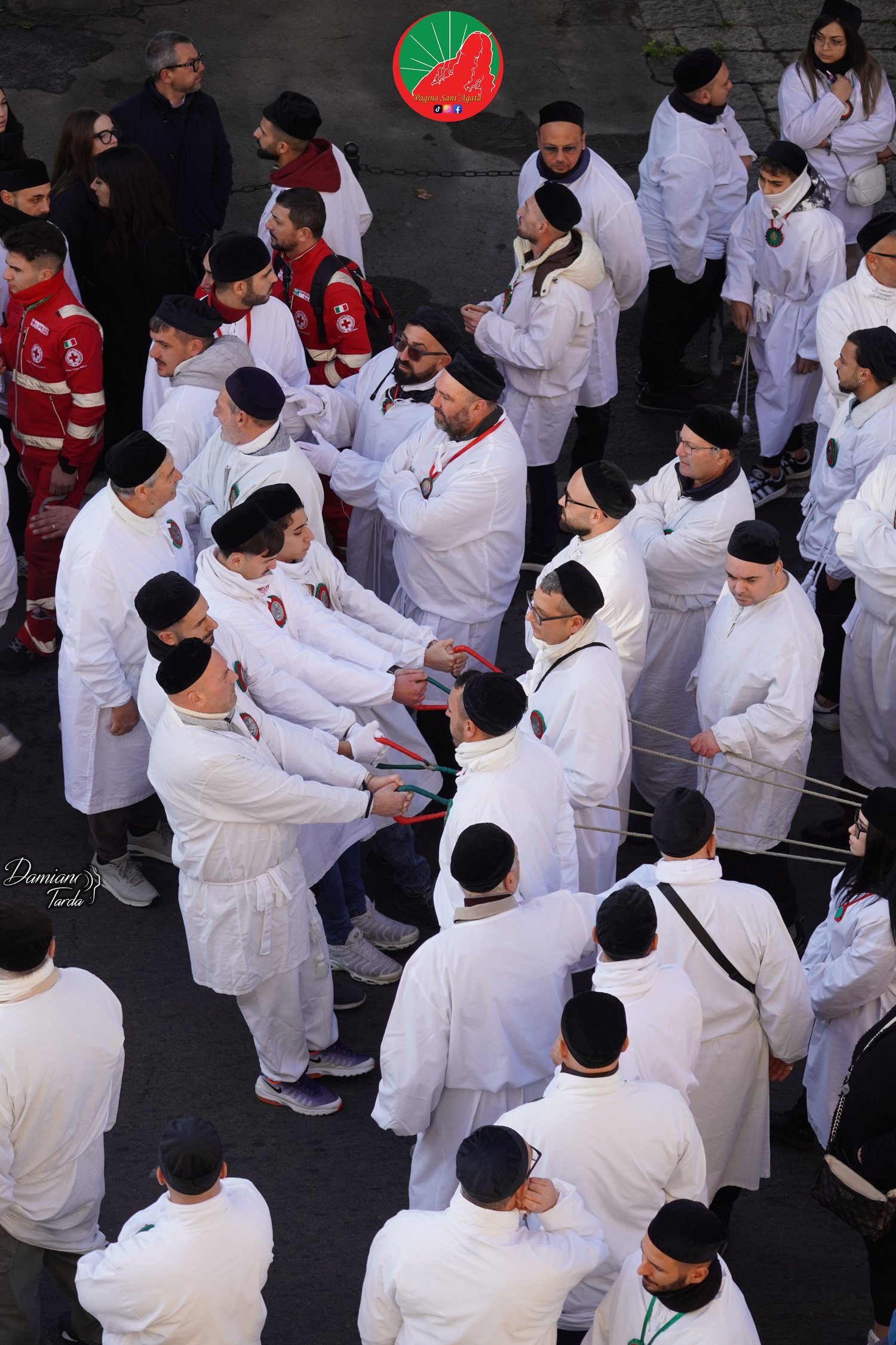 Portrait of devotees in white robes during the procession of Saint Agatha in Catania