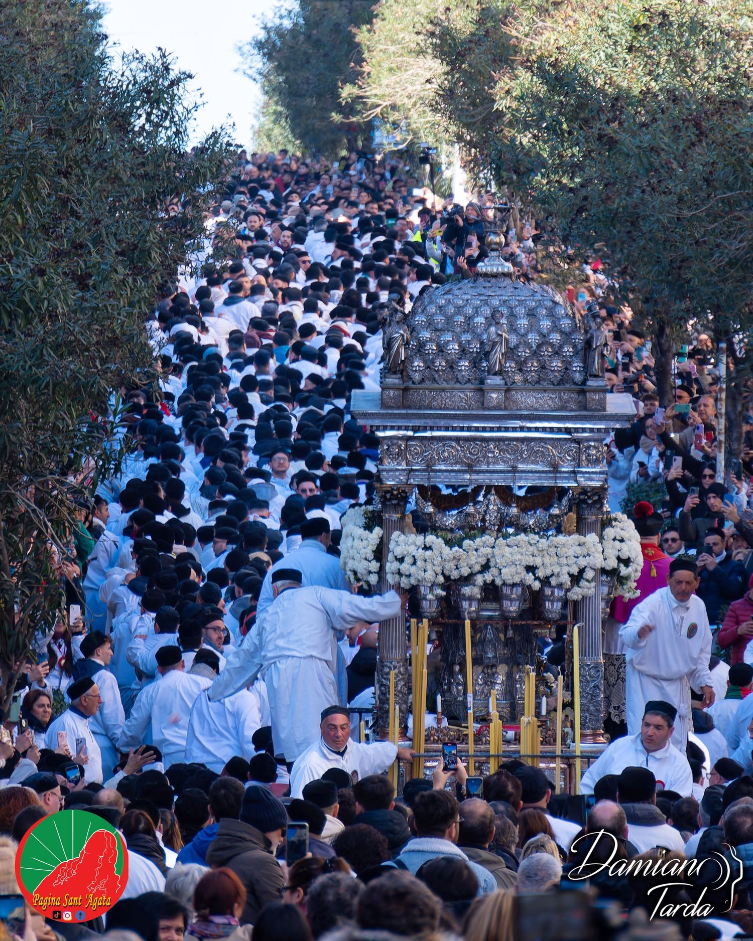 Portrait of devotees in white robes during the procession of Saint Agatha in Catania