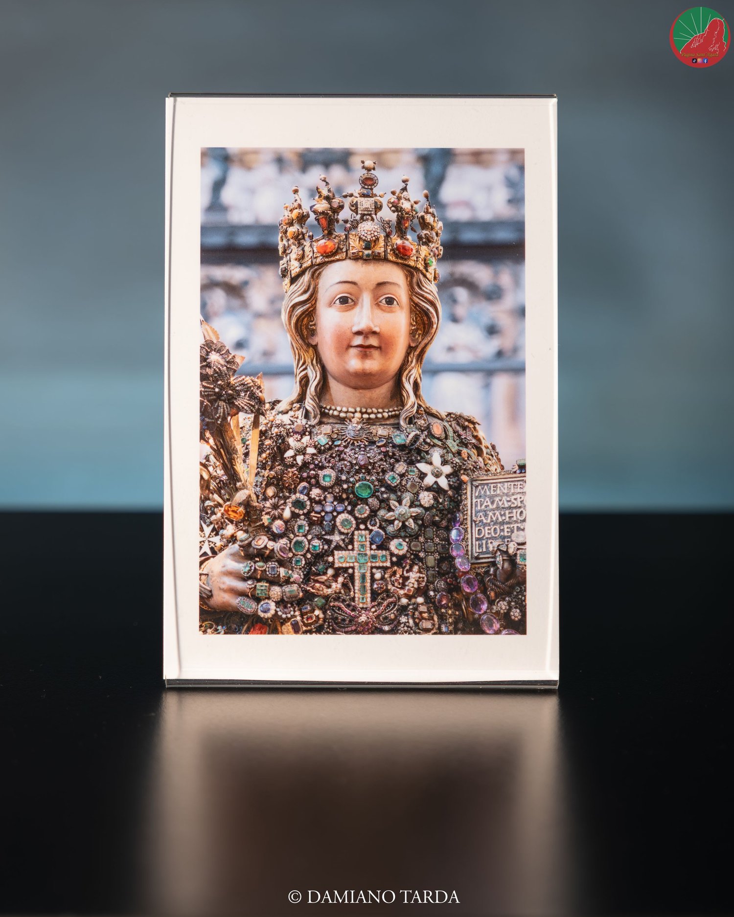 Photographic print of the face of Saint Agatha's reliquary bust, with crown and votive jewels.