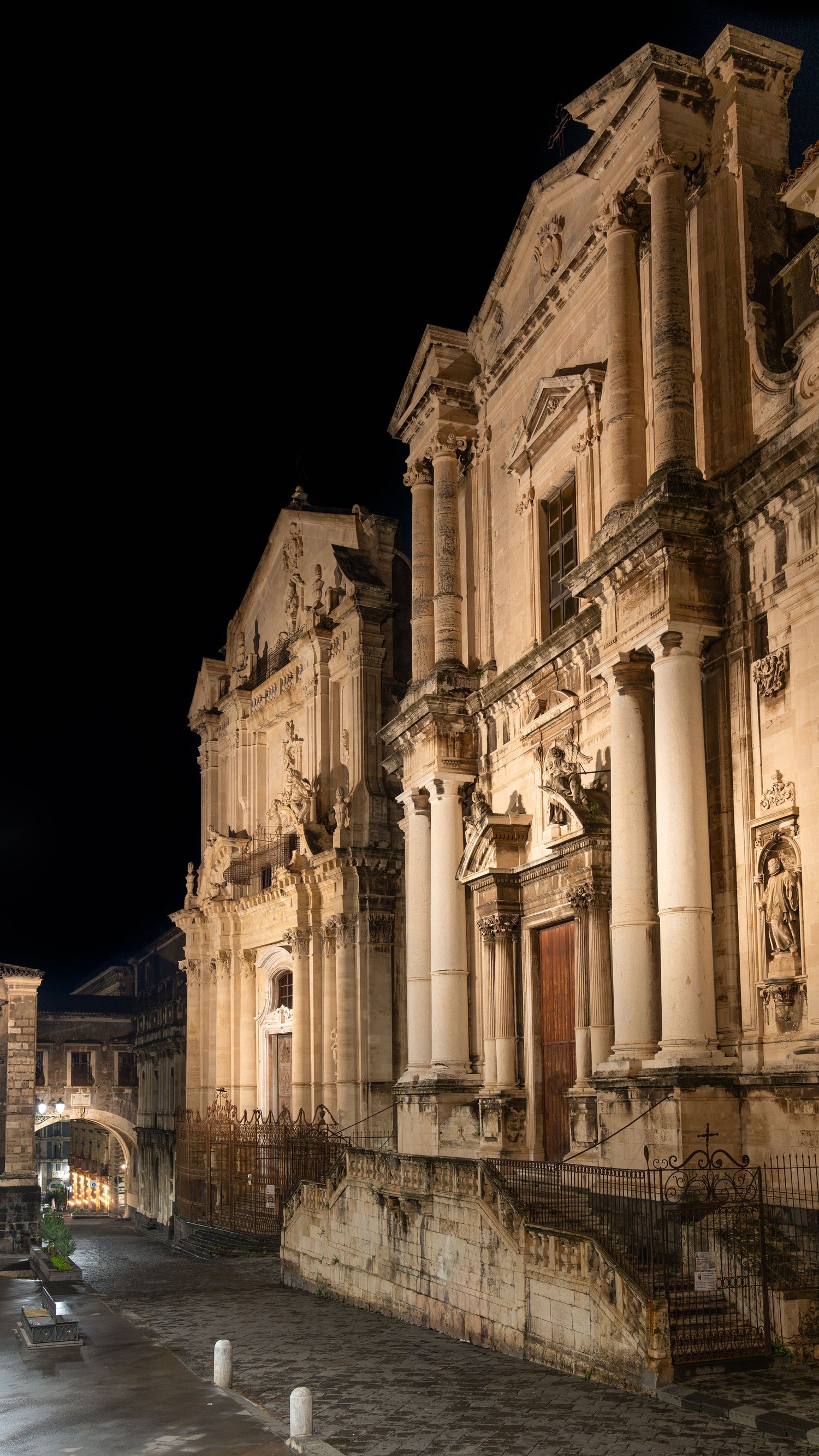 Via Crociferi, Catania's Baroque street in the evening, with the arch and the Church of San Benedetto. Sicilian architecture, urban photography